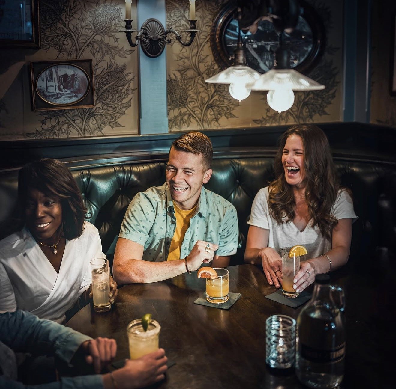 Friends toasting with cocktails at Tomboy Tavern