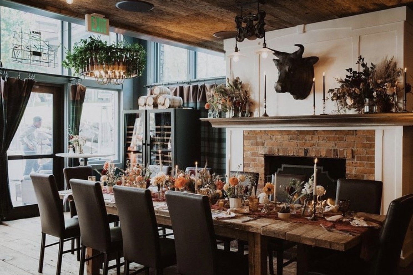 Long table set for a private dinner by the fireplace at Tomboy Tavern